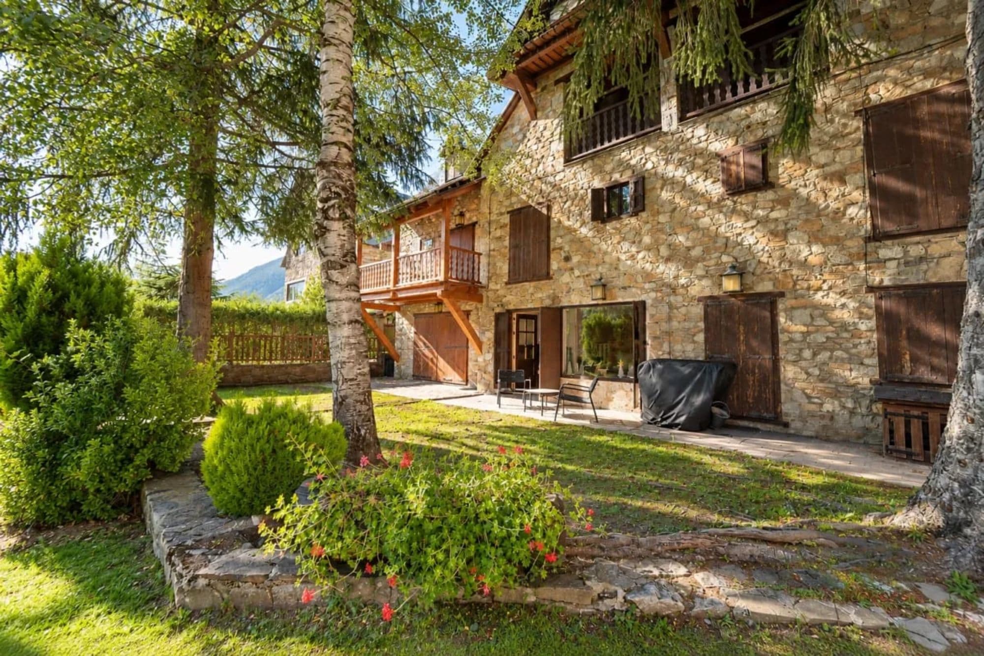 Stone mountain house with timber balconies and a private garden in Garòs, Val d’Aran