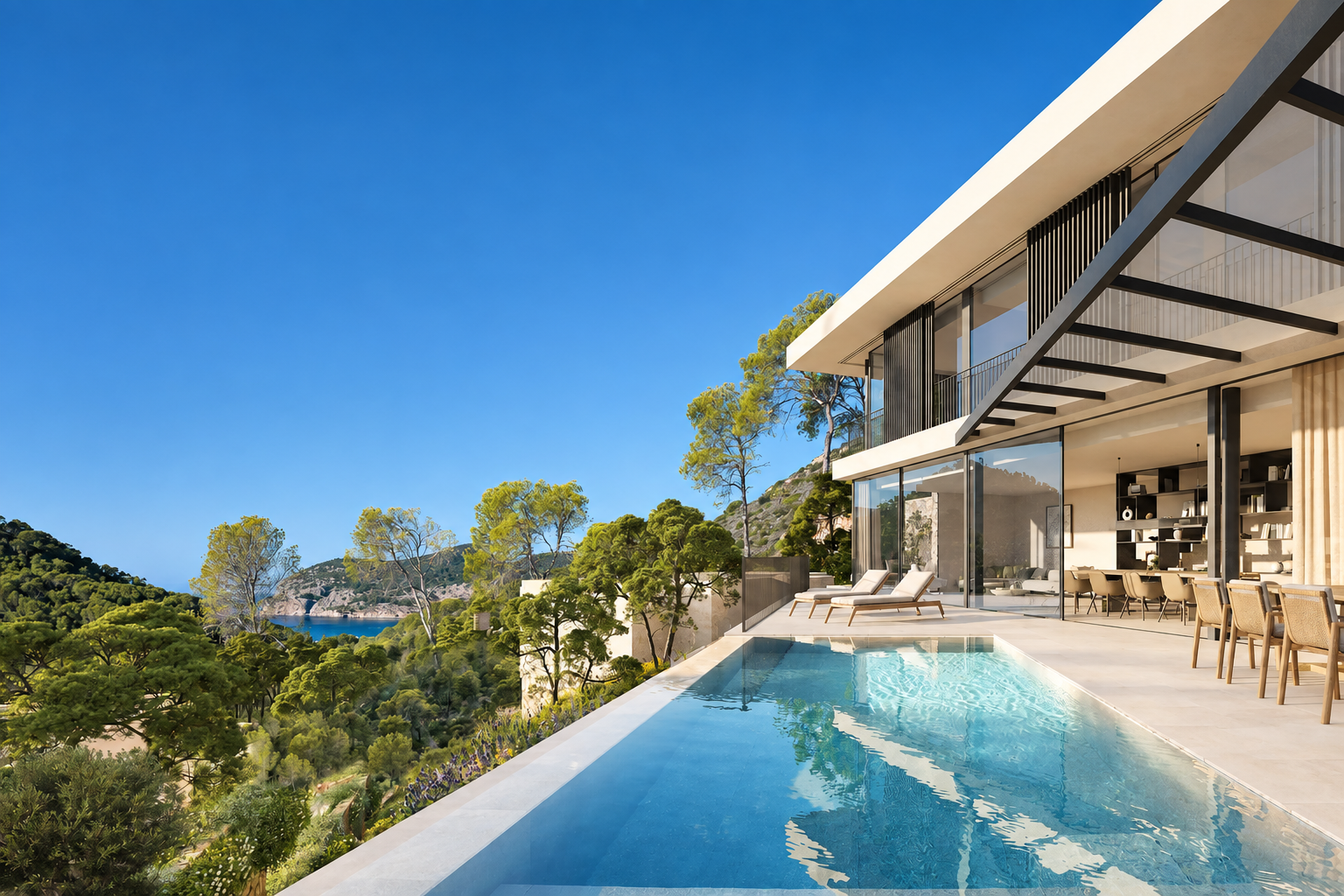 A sunlit villa terrace and pool overlooking a Mediterranean bay